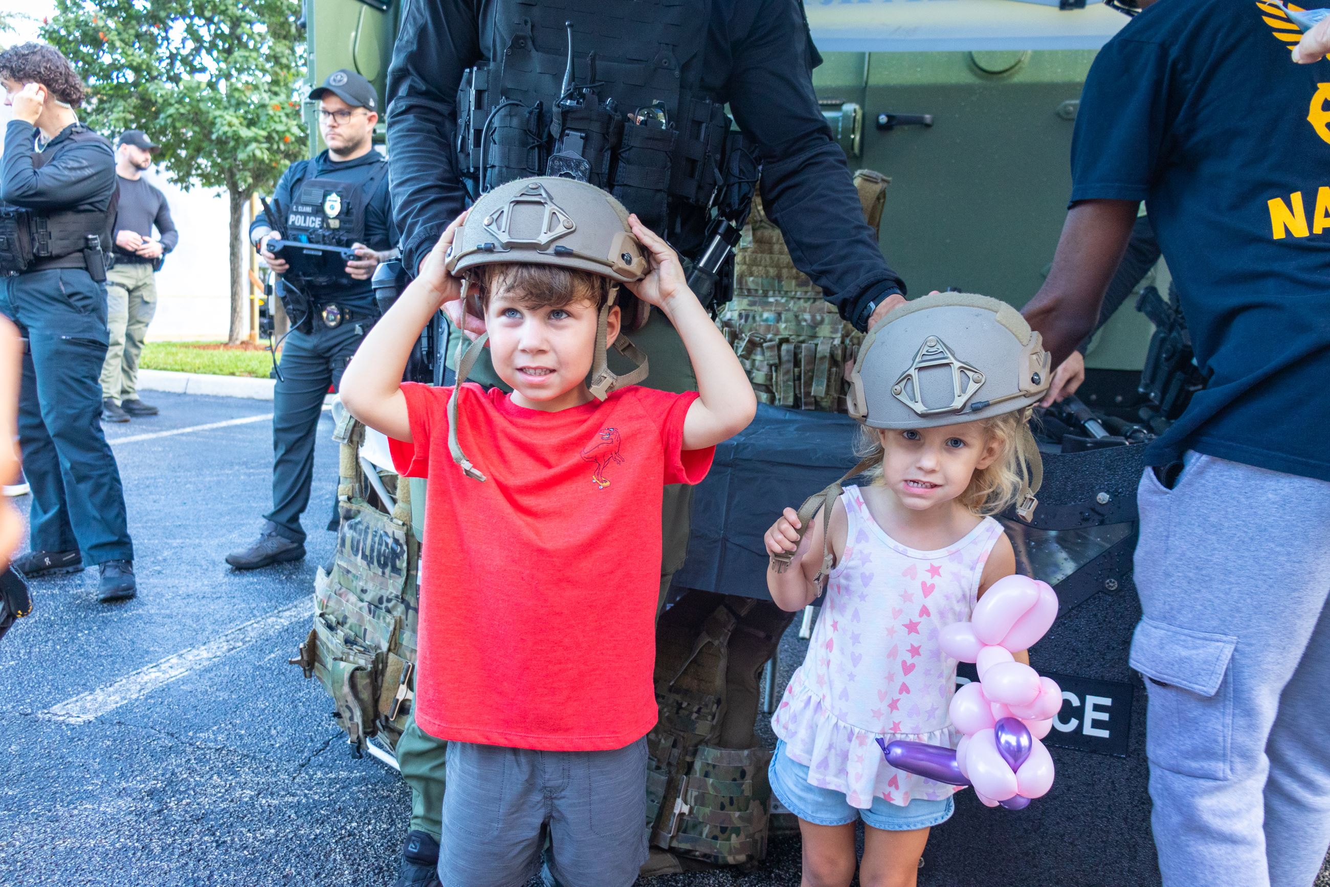 Two children happily try on Margate Police Special Response Team gear