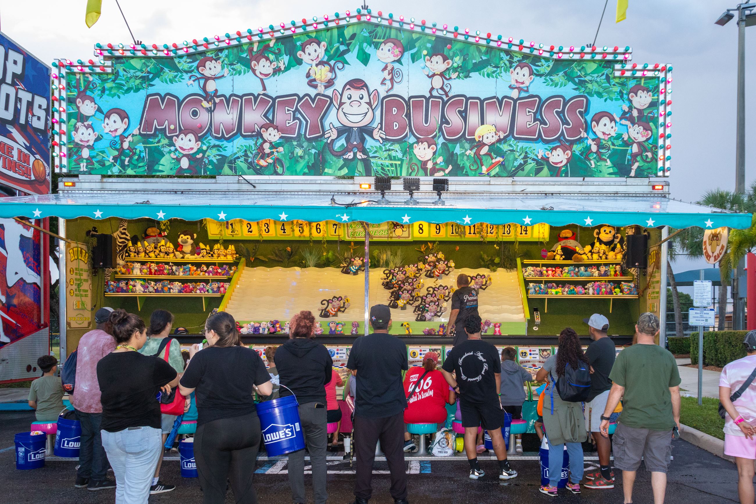 A crowd plays a carnival game